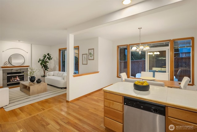7522 NE 204th Pl, Kenmore, WA 98028 - kitchen with dishwasher, tile countertops, light wood-style floors, a chandelier, and baseboards
