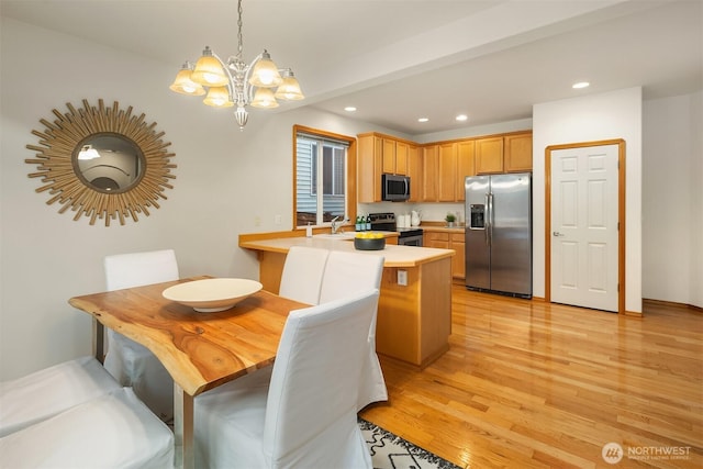 7522 NE 204th Pl, Kenmore, WA 98028 - kitchen with stainless steel appliances, a chandelier, recessed lighting, light wood-type flooring, and light countertops