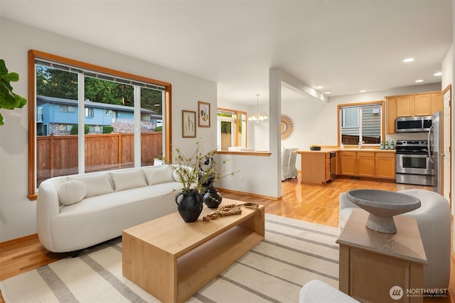 7522 NE 204th Pl, Kenmore, WA 98028 - living room with light wood-type flooring, baseboards, recessed lighting, and a chandelier
