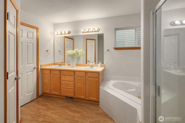 7522 NE 204th Pl, Kenmore, WA 98028 - bathroom with a garden tub, double vanity, wood finished floors, and a shower stall