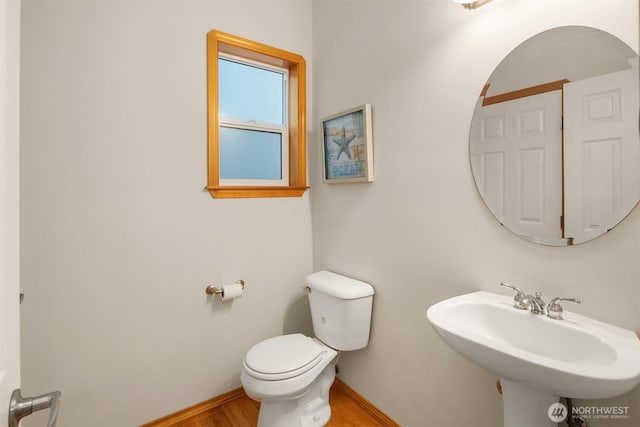 7522 NE 204th Pl, Kenmore, WA 98028 - half bath with toilet, a sink, wood finished floors, and baseboards