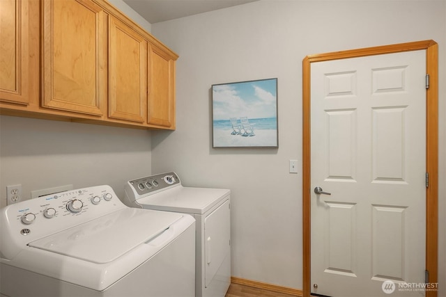 7522 NE 204th Pl, Kenmore, WA 98028 - washroom with cabinet space, washer and clothes dryer, and baseboards