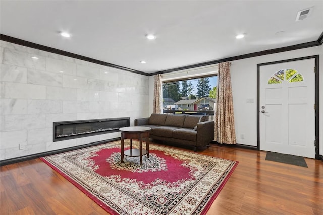 5004 188th St SW, Lynnwood, WA 98037 - living room with ornamental molding, wood finished floors, a tiled fireplace, and recessed lighting