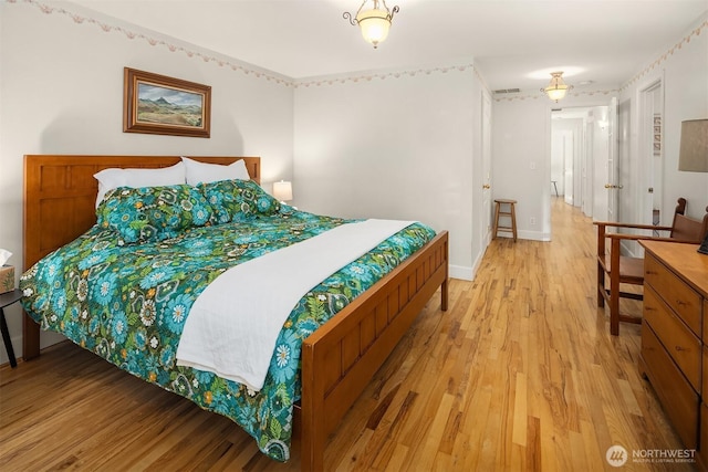 11002 Hyla Ave NE, Bainbridge Island, WA 98110 - bedroom featuring light wood-style flooring and baseboards