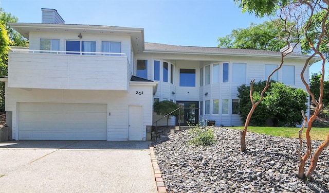 301 Canyon Pl, Wenatchee, WA 98801 - view of front of home with a chimney, driveway, an attached garage, and a balcony