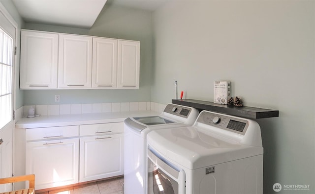 301 Canyon Pl, Wenatchee, WA 98801 - washroom with cabinet space, washer and dryer, healthy amount of natural light, and light tile patterned flooring