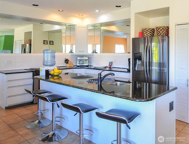 301 Canyon Pl, Wenatchee, WA 98801 - kitchen with stainless steel refrigerator with ice dispenser, freestanding refrigerator, tasteful backsplash, white cabinets, and recessed lighting