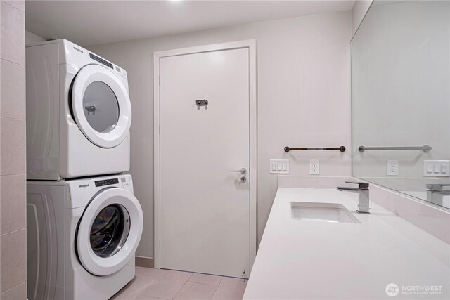 121 Stewart St Unit 2507, Seattle, WA 98101 - laundry area with stacked washer / drying machine and light tile patterned flooring