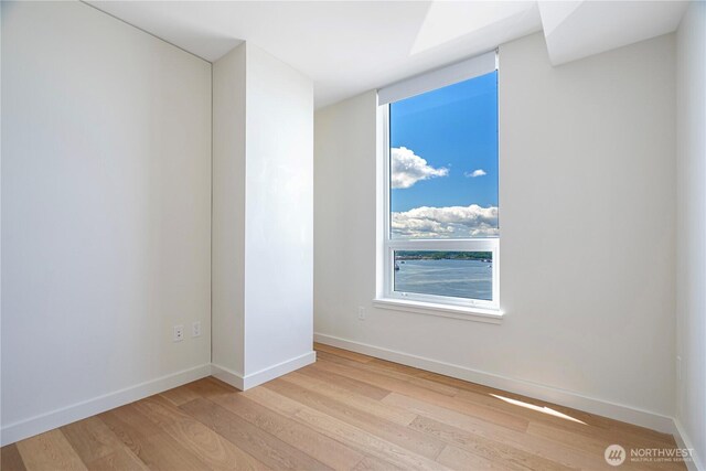 121 Stewart St Unit 2507, Seattle, WA 98101 - spare room featuring light wood-type flooring and baseboards