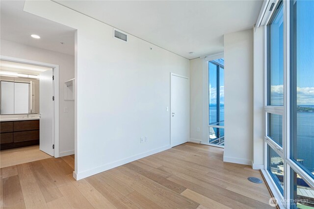 121 Stewart St Unit 2507, Seattle, WA 98101 - empty room with light wood finished floors and baseboards