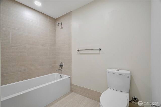 121 Stewart St Unit 2507, Seattle, WA 98101 - bathroom featuring toilet, bathing tub / shower combination, and tile patterned flooring