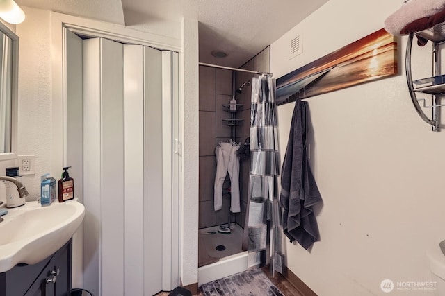 12304 NE 147th Ct, Kirkland, WA 98034 - bathroom with a shower stall, vanity, and wood finished floors