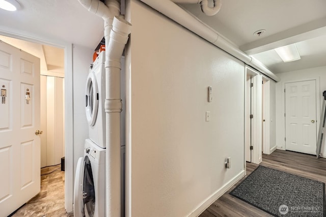 12304 NE 147th Ct, Kirkland, WA 98034 - laundry area with stacked washer / drying machine, wood finished floors, and baseboards