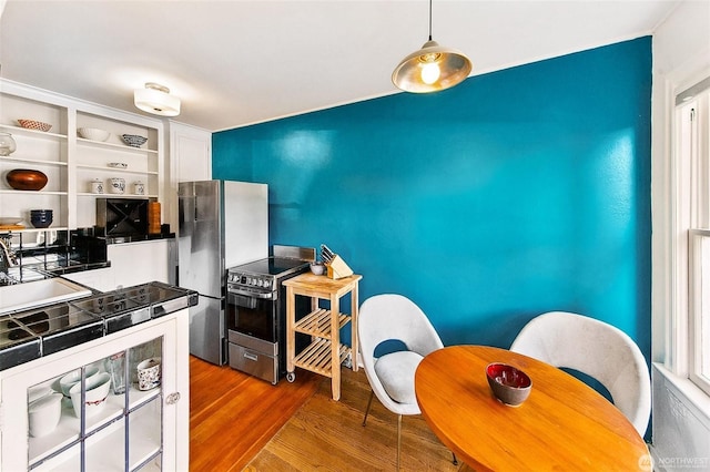 220 W Olympic Pl Unit 309, Seattle, WA 98119 - kitchen featuring appliances with stainless steel finishes, wood finished floors, a sink, and open shelves