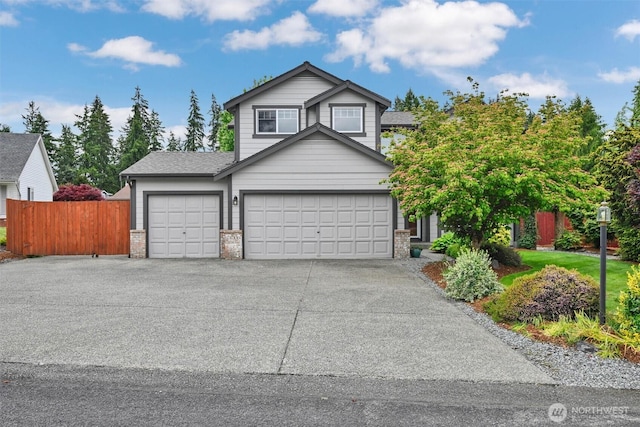24213 41st Ave E, Spanaway, WA 98387 - view of front of house with driveway, brick siding, and an attached garage