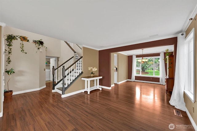 24213 41st Ave E, Spanaway, WA 98387 - entryway with washer / dryer, wood finished floors, a chandelier, baseboards, and ornamental molding
