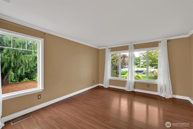 24213 41st Ave E, Spanaway, WA 98387 - spare room featuring baseboards, wood finished floors, and crown molding