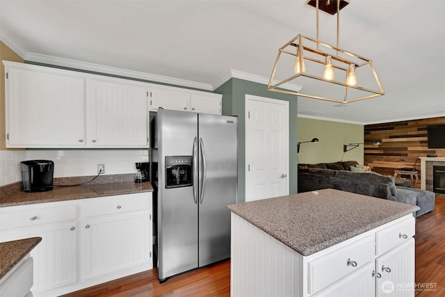 24213 41st Ave E, Spanaway, WA 98387 - kitchen featuring stainless steel fridge with ice dispenser, ornamental molding, white cabinetry, wood finished floors, and pendant lighting