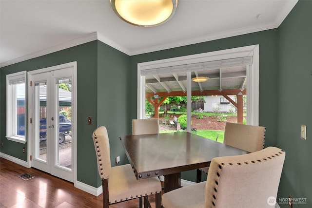 24213 41st Ave E, Spanaway, WA 98387 - dining space with healthy amount of natural light, wood finished floors, baseboards, and crown molding