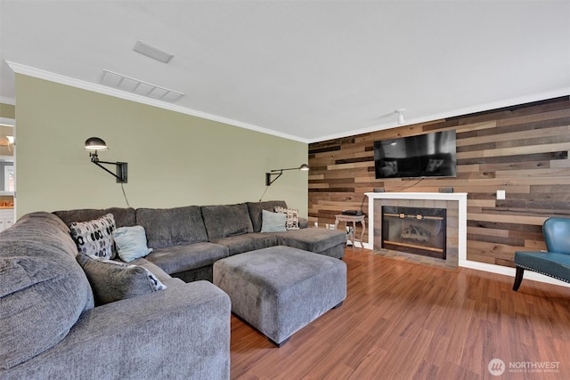 24213 41st Ave E, Spanaway, WA 98387 - living room with crown molding, wood finished floors, wooden walls, and a fireplace