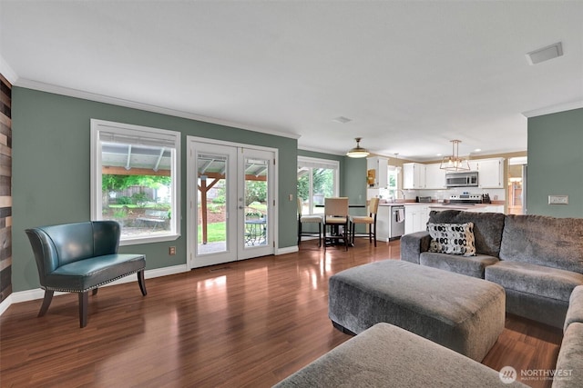 24213 41st Ave E, Spanaway, WA 98387 - living room featuring ornamental molding, baseboards, and dark wood-type flooring