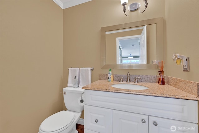 24213 41st Ave E, Spanaway, WA 98387 - bathroom with vanity, toilet, and ornamental molding