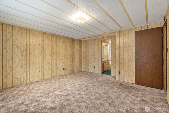 7300 32nd Ave NE Unit 5, Olympia, WA 98516 - unfurnished bedroom featuring carpet, wood walls, and ensuite bath