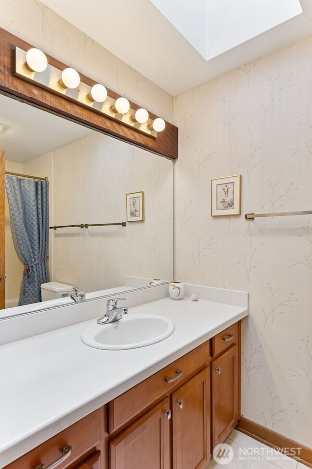 5019 E Mercer Way, Mercer Island, WA 98040 - bathroom featuring vanity, toilet, wallpapered walls, a skylight, and curtained shower