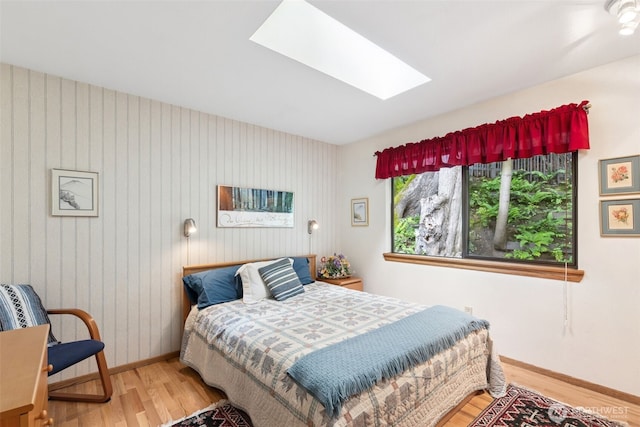 5019 E Mercer Way, Mercer Island, WA 98040 - bedroom featuring wood finished floors, baseboards, and a skylight