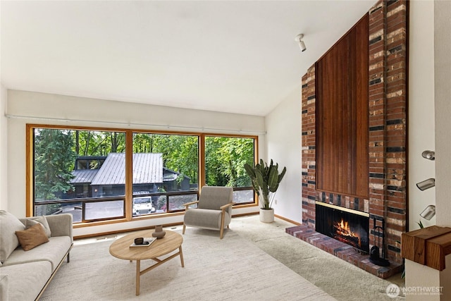 5019 E Mercer Way, Mercer Island, WA 98040 - carpeted living room featuring healthy amount of natural light, a fireplace, and vaulted ceiling