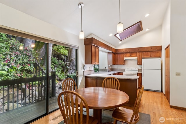 5019 E Mercer Way, Mercer Island, WA 98040 - kitchen with white appliances, a skylight, light countertops, under cabinet range hood, and a sink