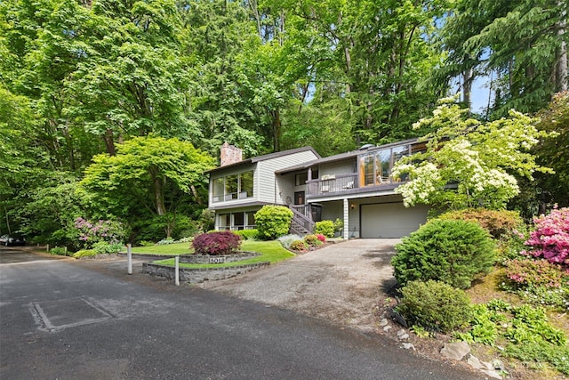 5019 E Mercer Way, Mercer Island, WA 98040 - view of front facade featuring an attached garage, a chimney, driveway, and stairs