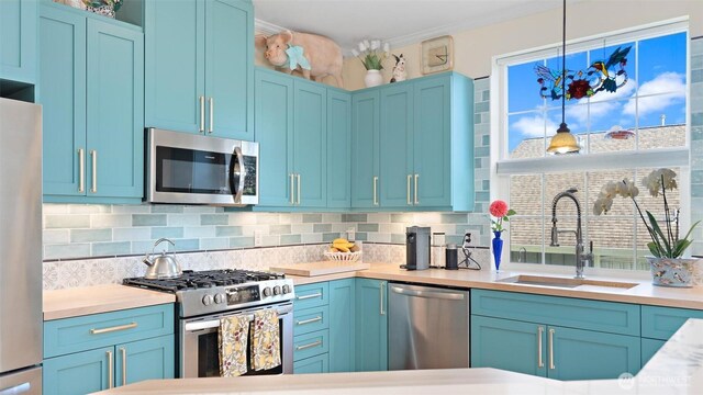 221 NE Honey Locust Ct, Poulsbo, WA 98370 - kitchen featuring stainless steel appliances, a sink, and blue cabinetry