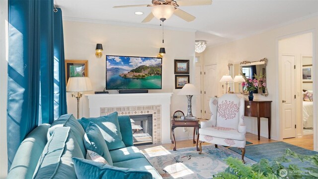 221 NE Honey Locust Ct, Poulsbo, WA 98370 - living room with ceiling fan, wood finished floors, ornamental molding, recessed lighting, and a brick fireplace