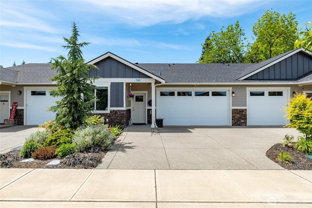 742 Parkland Loop, Sedro Woolley, WA 98284 - view of front of house featuring board and batten siding, stone siding, a garage, and concrete driveway