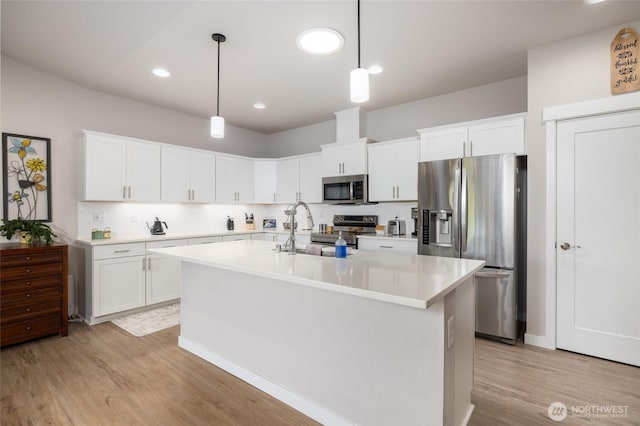 742 Parkland Loop, Sedro Woolley, WA 98284 - kitchen featuring stainless steel appliances, a sink, light wood finished floors, light countertops, and recessed lighting