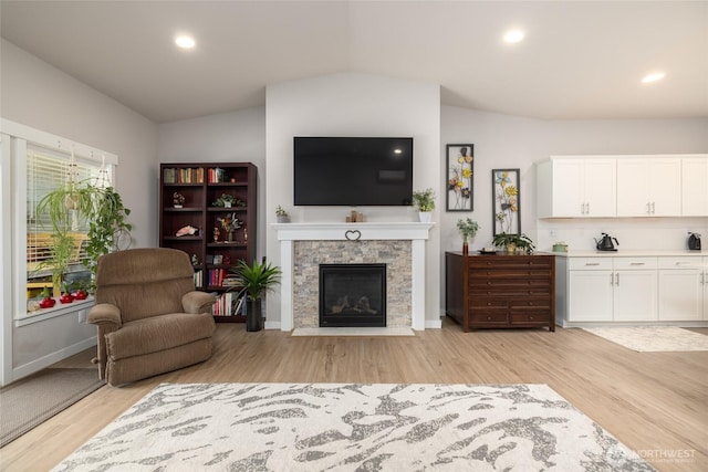 742 Parkland Loop, Sedro Woolley, WA 98284 - living room with vaulted ceiling, light wood-style flooring, a fireplace, recessed lighting, and baseboards