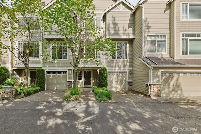 11800 SE 4th Pl Unit 203, Bellevue, WA 98005 - townhome / multi-family property with stone siding, driveway, and a garage
