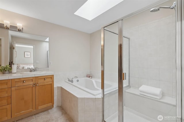 11800 SE 4th Pl Unit 203, Bellevue, WA 98005 - bathroom with vanity, a bath, a stall shower, a skylight, and tile patterned flooring