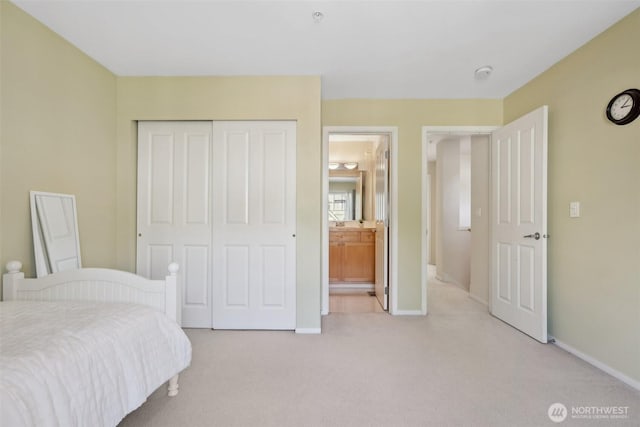11800 SE 4th Pl Unit 203, Bellevue, WA 98005 - bedroom with light colored carpet, a closet, baseboards, and connected bathroom