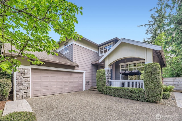 3402 174th Pl SE, Bothell, WA 98012 - view of front of house featuring covered porch, driveway, a garage, and stone siding