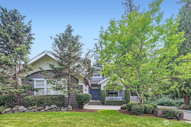 3402 174th Pl SE, Bothell, WA 98012 - obstructed view of property with a front lawn and board and batten siding