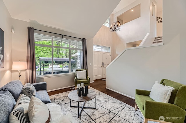 3402 174th Pl SE, Bothell, WA 98012 - living area featuring baseboards, wood finished floors, a chandelier, and a high ceiling
