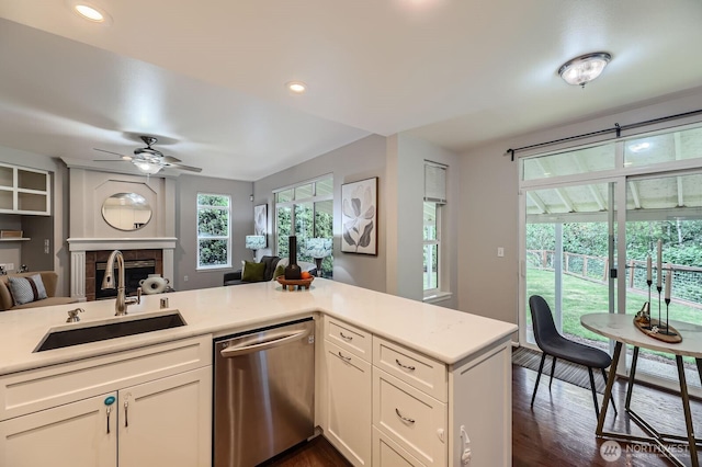 3402 174th Pl SE, Bothell, WA 98012 - kitchen featuring stainless steel dishwasher, a sink, a fireplace, open floor plan, and light countertops