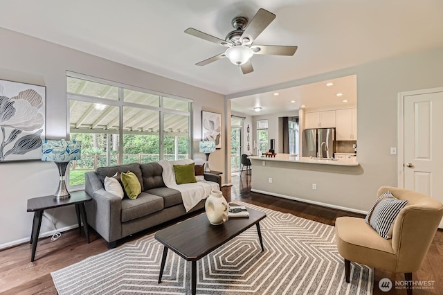 3402 174th Pl SE, Bothell, WA 98012 - living room featuring a ceiling fan, dark wood-style flooring, and baseboards