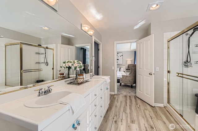 3402 174th Pl SE, Bothell, WA 98012 - ensuite bathroom featuring double vanity, a stall shower, and wood finished floors