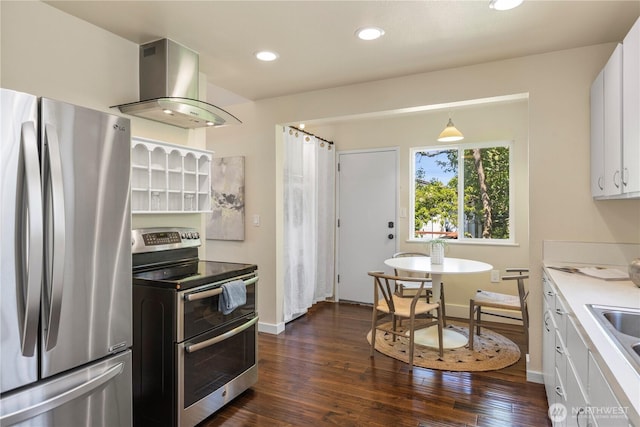 1220 SW Orchard St, Seattle, WA 98106 - kitchen with appliances with stainless steel finishes, wall chimney range hood, white cabinetry, dark wood-style flooring, and recessed lighting