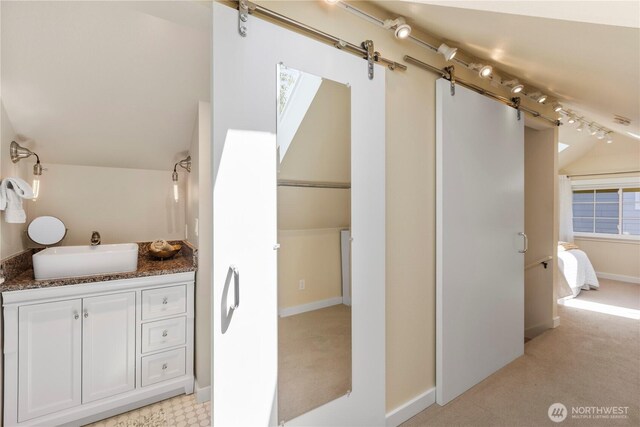 1220 SW Orchard St, Seattle, WA 98106 - ensuite bathroom with vanity, vaulted ceiling, and baseboards