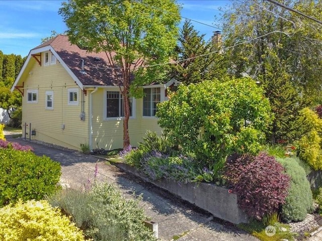 1220 SW Orchard St, Seattle, WA 98106 - view of side of home with roof with shingles