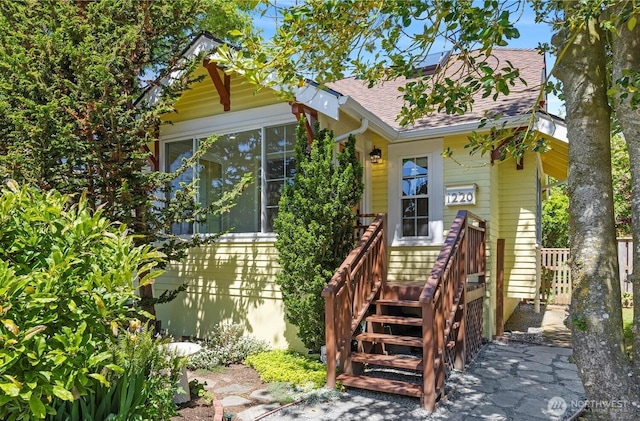 1220 SW Orchard St, Seattle, WA 98106 - view of front of house featuring roof with shingles and a sunroom